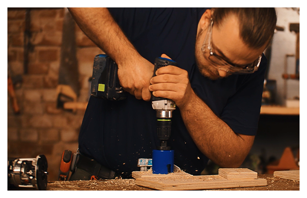 große Löcher werden in ein Holzbrett gefräst